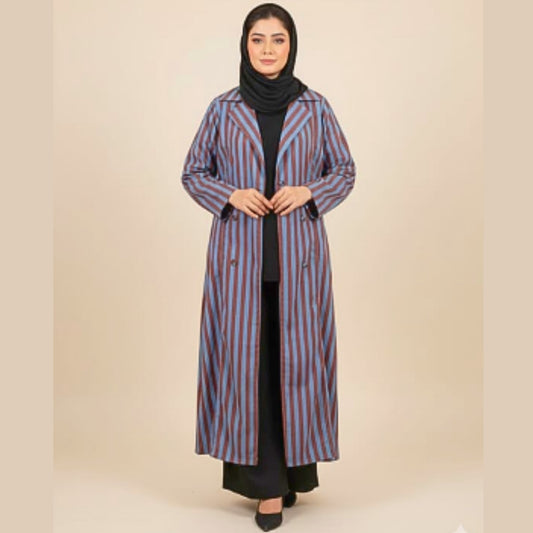 Woman wearing a long striped coat on a beige background