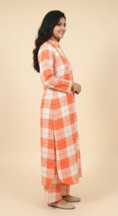 Woman wearing an orange and white checkered dress on a beige background