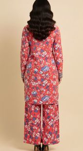 Person wearing a red floral outfit on a beige background