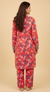 Woman wearing a red floral outfit on a beige background