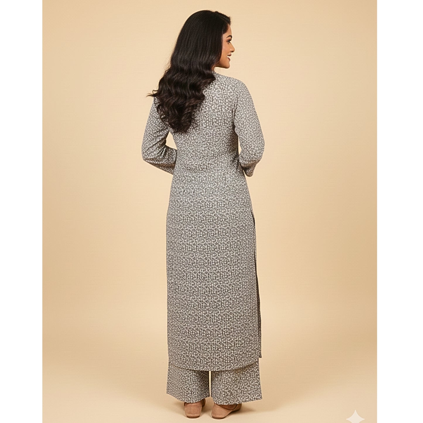 Woman wearing a long, patterned dress on a beige background