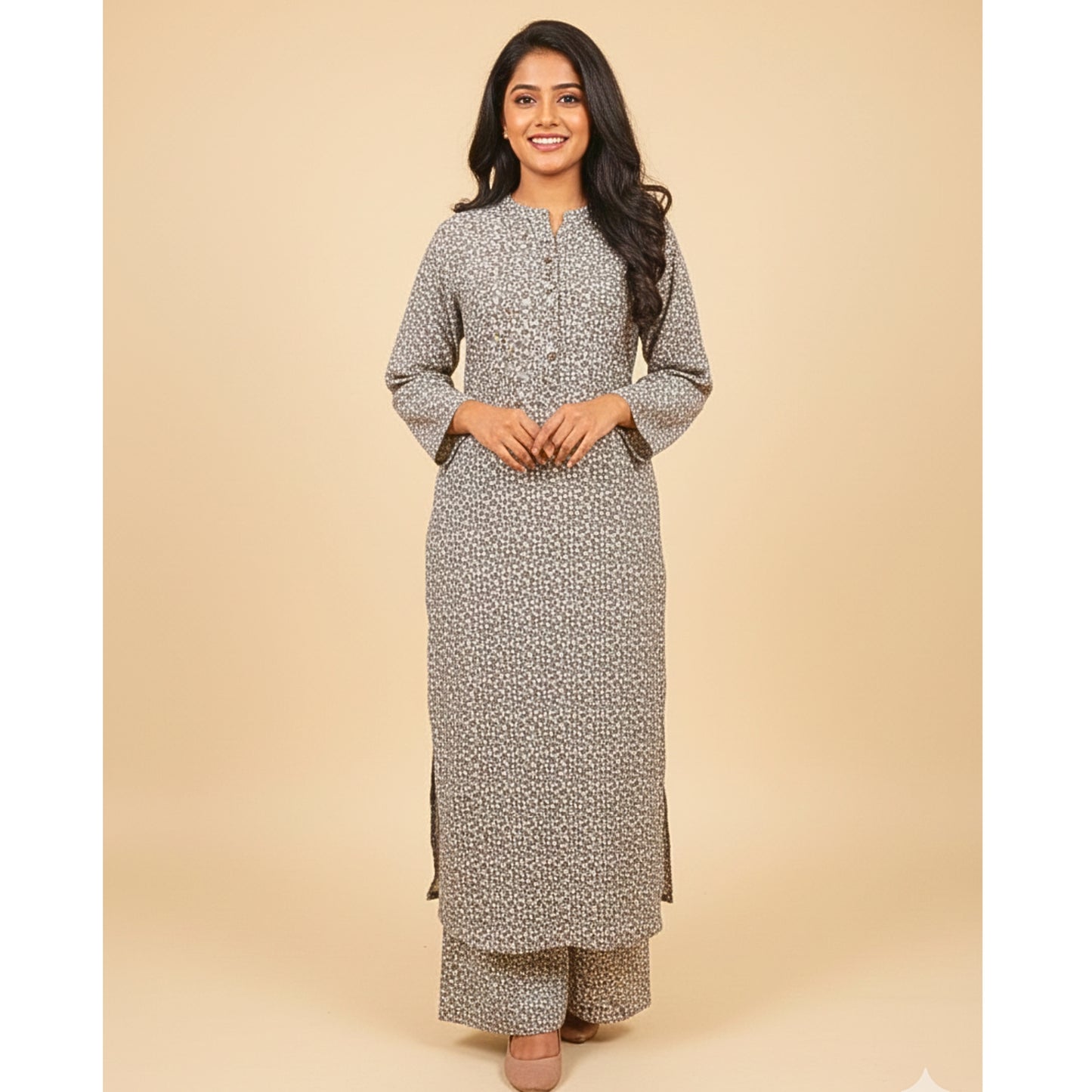 Woman wearing a long, patterned dress against a beige background