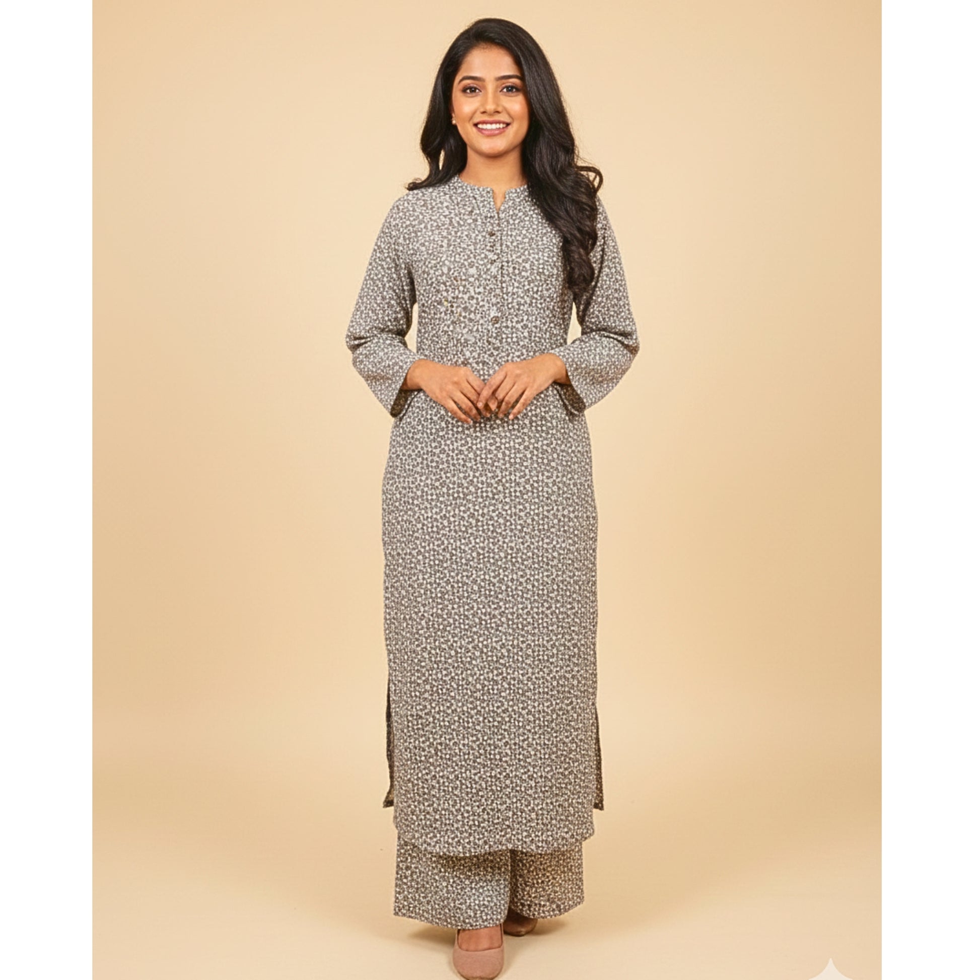 Woman wearing a long, patterned dress against a beige background