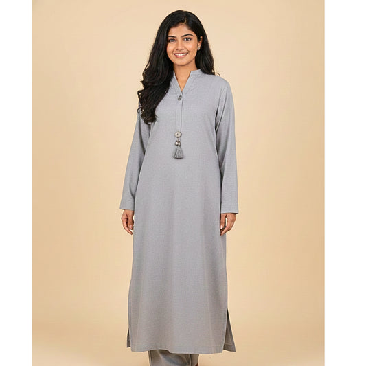 Woman wearing a gray kurta with tassels on a beige background