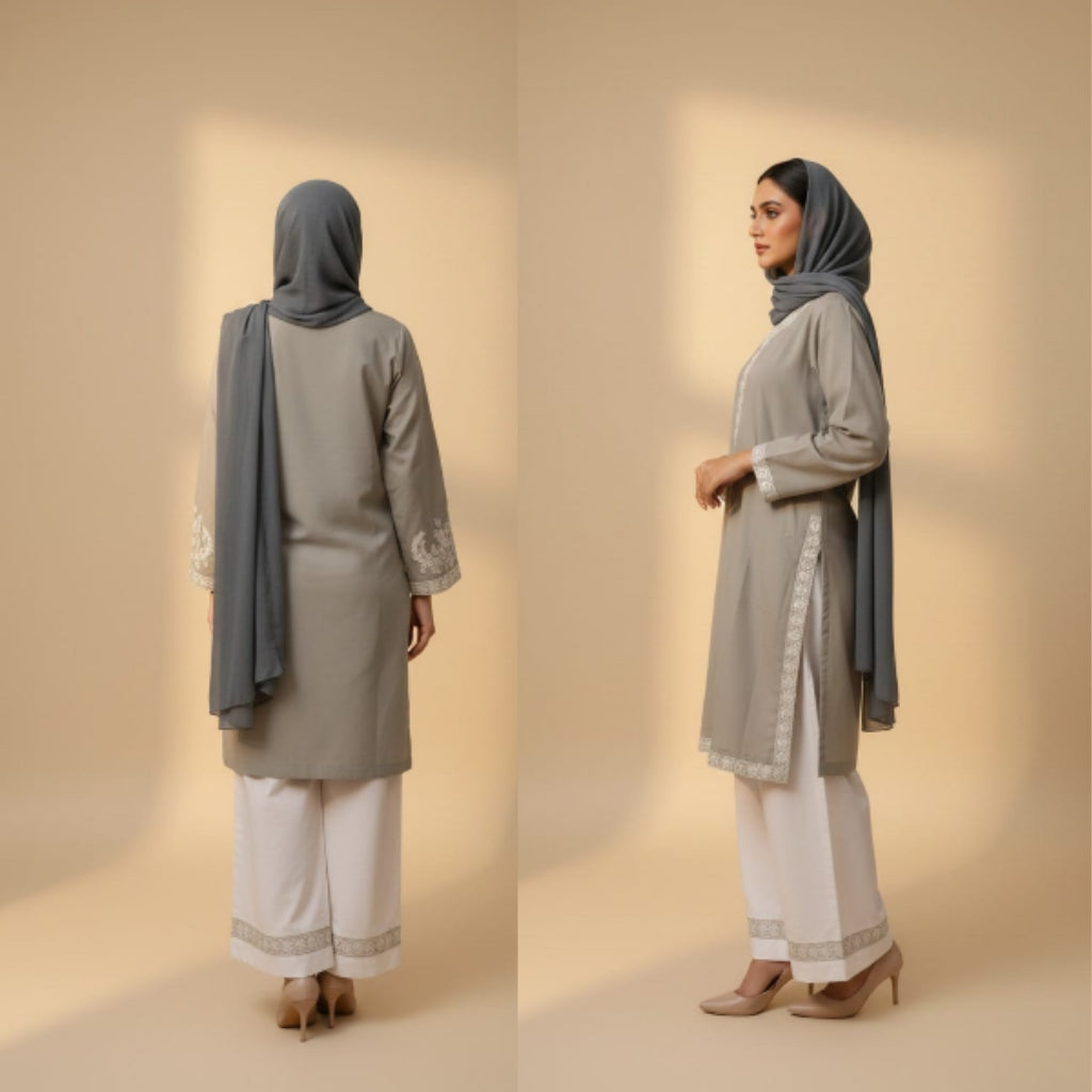 Woman modeling a gray and white traditional outfit with a hijab against a beige background